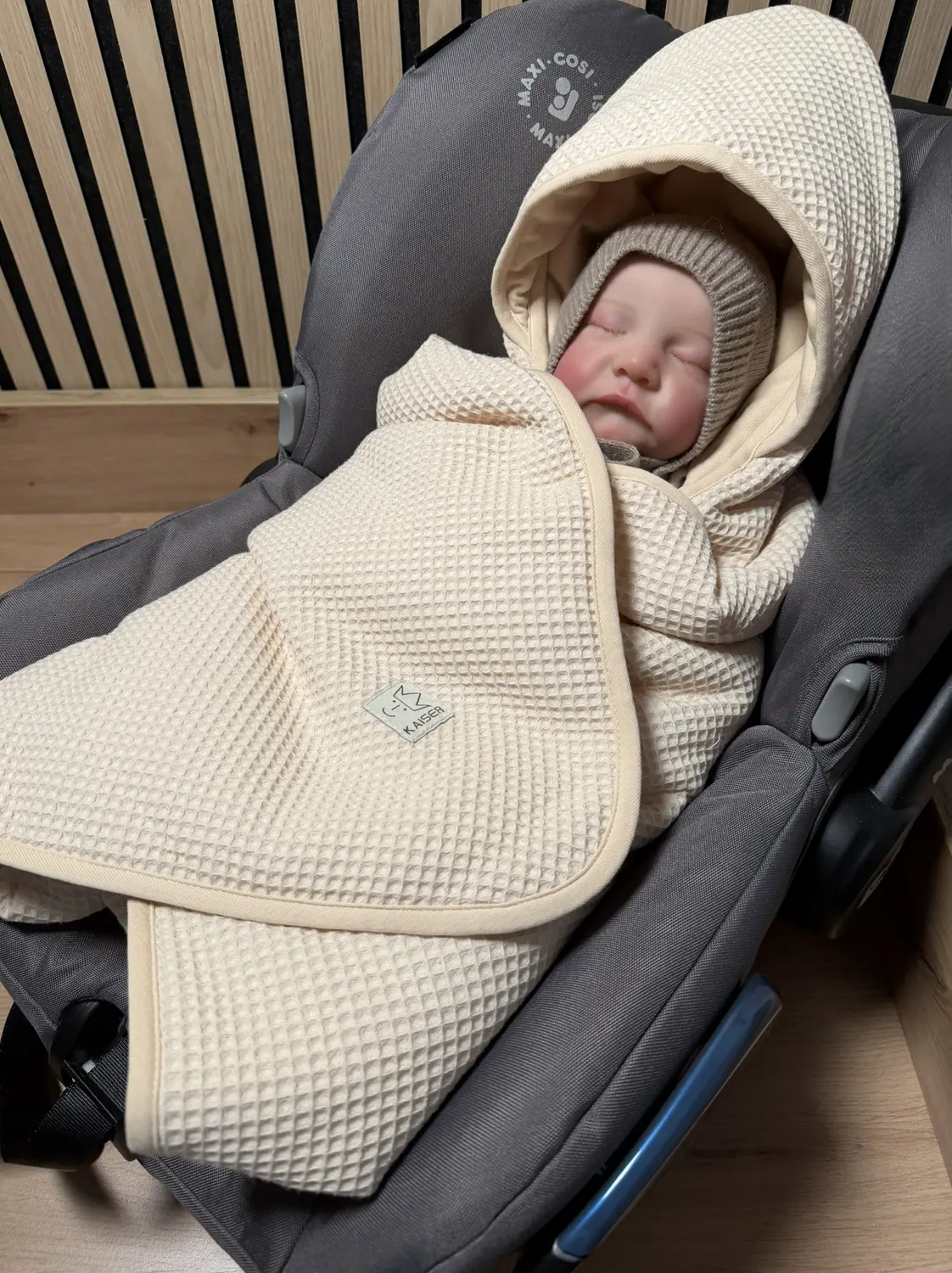 Kaiser Einschlagdecke wwaffel cream lifestylebild Kind in Babyschale